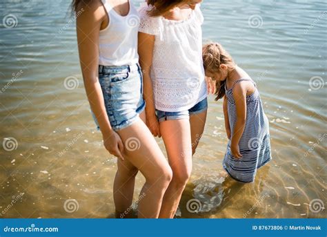 Mature Mother With Two Daughters Spending Summer Day Outdoors Stock