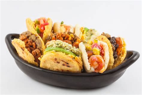 Arepas With Two Different Fillings Served In A Black Ceramic Dish Stock Photo - Image of ceramic ...