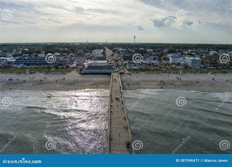 Aerial Shot Of The Kure Beach Pier With Ocean Water Waves People On