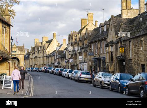 Lots Of Cars Parked Along Road In Popular Historic Cotswolds Village