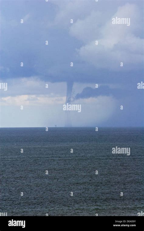 Waterspout Forming Over An Oil Rig In The Atlantic Ocean In The Gulf Of