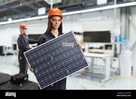 solar panel production workers   factory holding photovoltaics