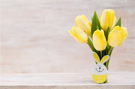 Premium Photo Yellow Tulips Spring Flowers And Easter Decoration