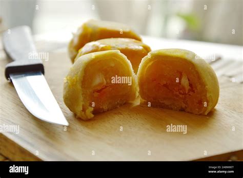 Chinese Pastry Filled Mashed Bean And Salty Egg Yolk On Wooden Chop