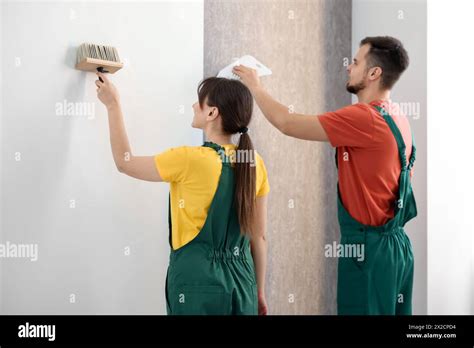 Workers Hanging Stylish Gray Wallpaper In Room Stock Photo Alamy
