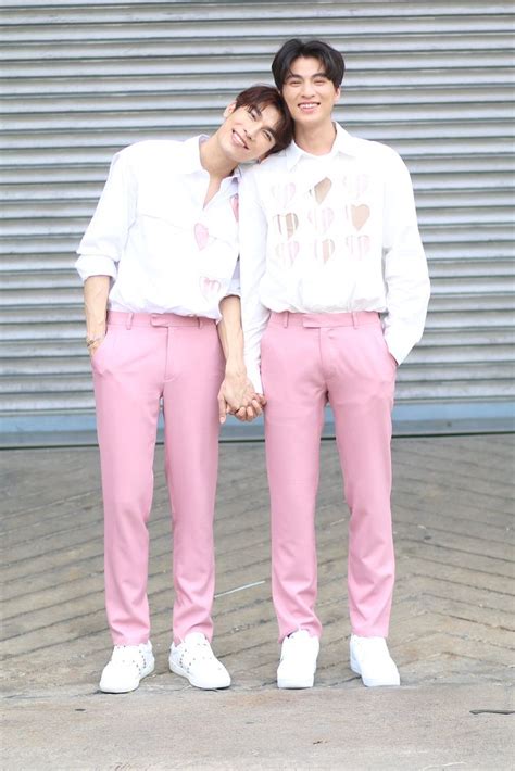 Two People Standing Next To Each Other In Front Of A Garage Door