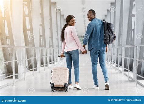 Couple Travelling Concept Romantic Black Spouses Walking With Luggage In Airport Stock Image