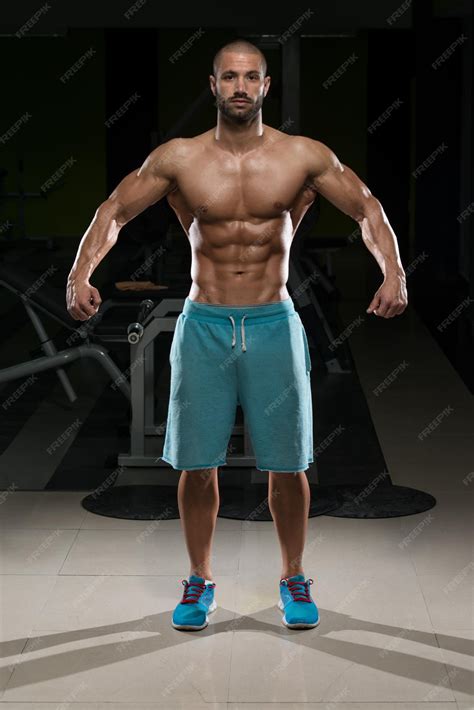 Premium Photo | Portrait of a physically fit man showing his well