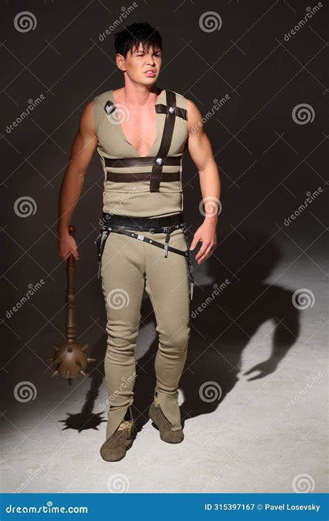 Strong Young Man In A Costume Holding Mace In His Stock Image Image
