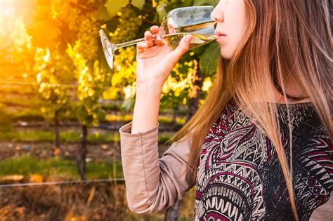 Gorgeous Brunette Woman Having Wine Fun In The Vineyards Premium Photo