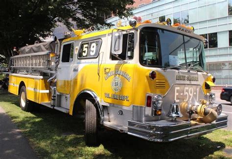 an old fire truck is parked on the grass