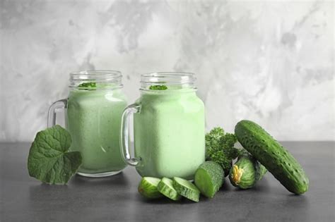 Premium Photo Mason Jars With Fresh Smoothie And Cucumbers On Table