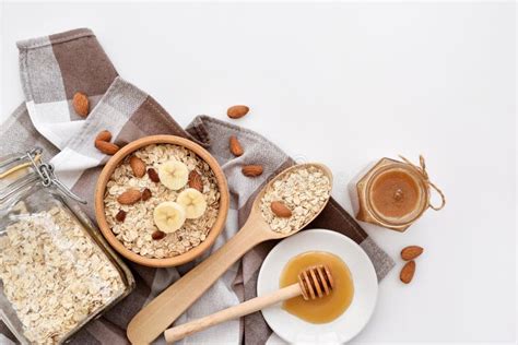 Oatmeal In A Wooden Bowl With Almonds And Pieces Of Banana Ready To