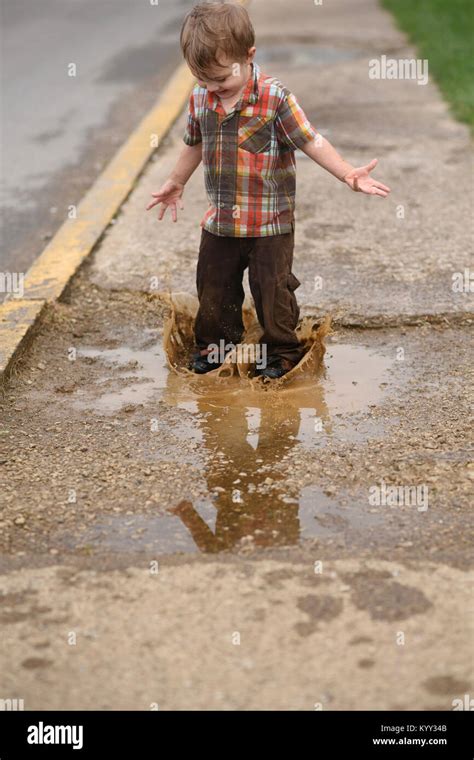 Boy Jumping In Puddle Hi Res Stock Photography And Images Alamy