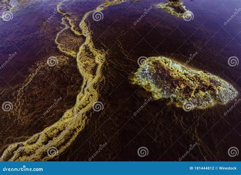 Closeup Of Rocks In Red Acidic And Polluted Rio Tinto River Due To