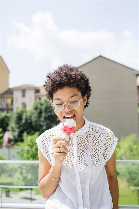 Woman Licking An Ice Cream In A Sunny Day By Stocksy Contributor