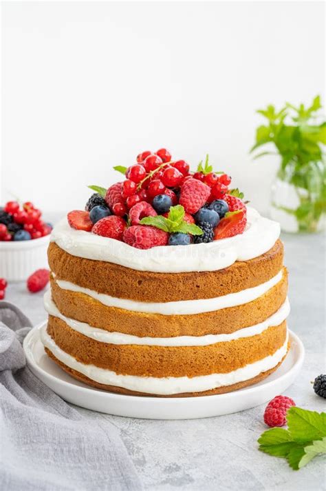 Homemade Naked Layered Vanilla Cake With Whipped Cream And Fresh Berries On Top On A Gray