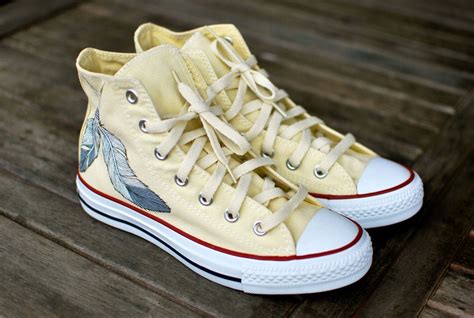 White Converse Chuck Taylor Hi Tops featuring dream catcher