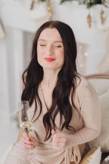 Premium Photo A Woman Is Holding A Champagne Glass And Smiling