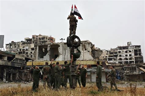 Syria Assad S Forces Raise Their Flag Among The Ruins As Rebels Leave Homs