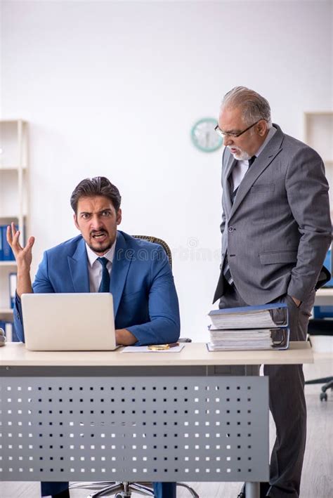 Jefe Masculino Viejo Y Empleado Joven Que Trabaja En La Oficina Imagen