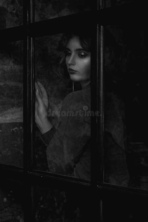 Fashionable Brunette Model Wearing Blouse Posing Behind The Glass Door Black And White Toning