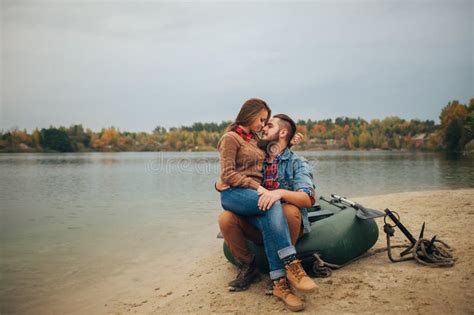 Young Couple In Love Boat Ride On The River Next To The Forest Stock