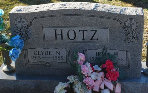 The Headstone Of Clyde N Clyd Is Surrounded By Flowers And Other