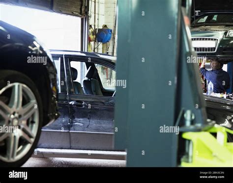 Male Mechanic Working Under Car In Auto Repair Shop Stock Photo Alamy