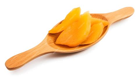 Premium Ai Image Dried Mango Slices In Wooden Spoon Isolated On White