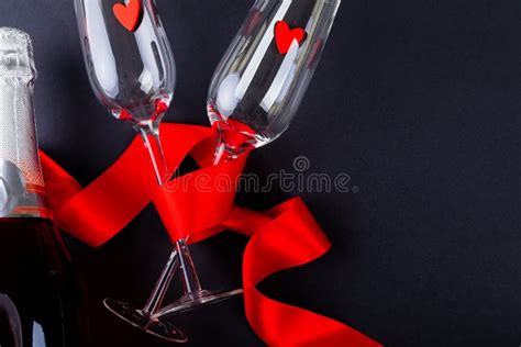 Red Ribbon Wrapping Flutes With Heart Shapes By Champagne Bottle And