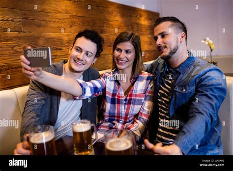 Happy Friends Taking Selfie At Restaurant Stock Photo Alamy