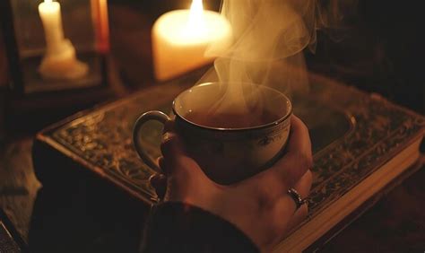 Person Holding A Steaming Cup Of Hot Beverage Premium AI Generated Image