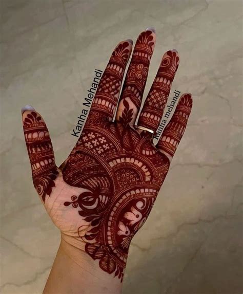 The Hand Is Decorated With Henna Designs On It