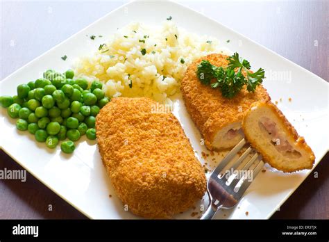 Breaded Stuffed Chicken Cordon Bleu With Green Peas White Rice And