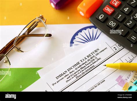 Indian Income Tax Return Blank Form With Pen And Indian Rupees Bills On