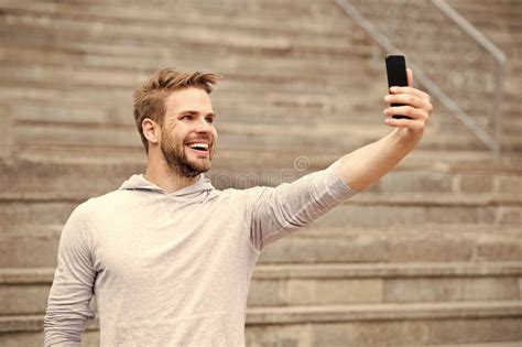 Man With Beard Walks With Smartphone Urban Background With Stairs Man