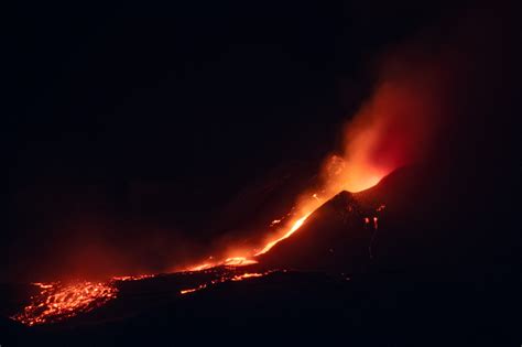 Etna volcano eruption. It throws out lava and clouds of smoke