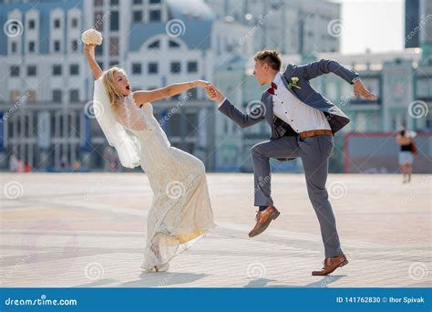 Bride And Groom In Wedding Attire Dancing Fiery Dance In The Town Stock