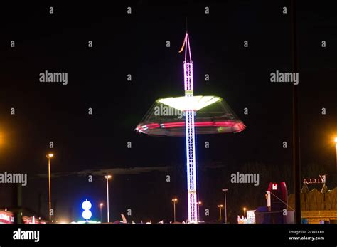 Spinning Carousel Blurred By Motion In Amusement Park At Night In