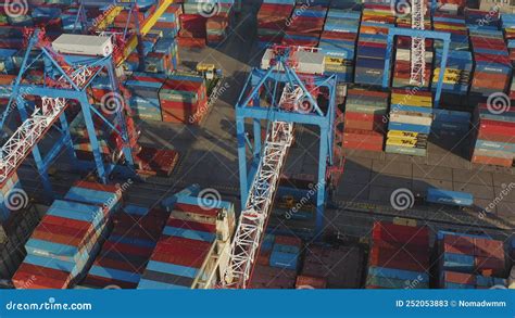 Cargo Containers Being Unloaded By A Gantry Crane From A Container Ship