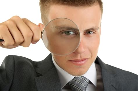 Premium Photo Young Businessman Looking Through Magnifying Glass