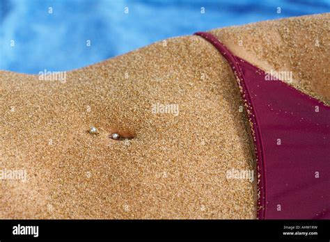 Close Up Of Sandy Belly Piercing In Belly Button Bikini Bottom In