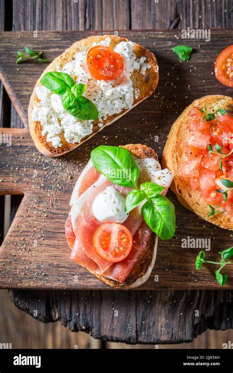 Homemade And Aromatic Mix Of Bruschetta As Classic Snack For Breakfast