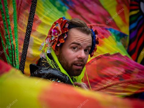 Un joven caucásico en el orgullo gay de París luciendo barba mirando a la cámara y