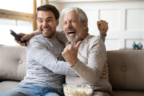 Happy Mature Dad And Grownup Son Watch Football Together Stock Photo Image Of Aged Person