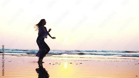 Silhouette of young woman performing grand jete jump on the beach in slow motion Stock Video ...