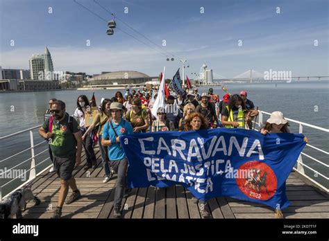 Activists Are Seen Marching With Banners In Defense Of The Environment