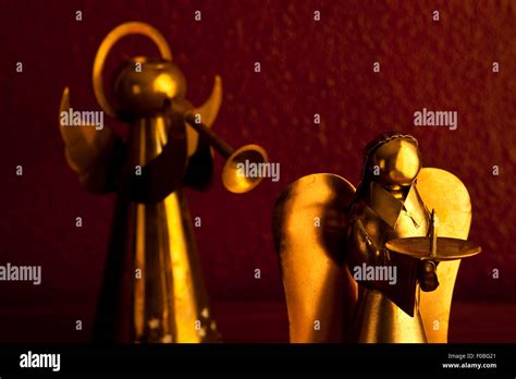 Bronze Metal angels playing music standing on desk candle holders Stock ...