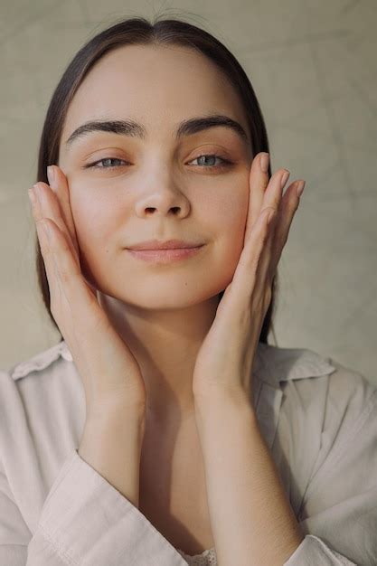 Premium Photo Portrait Of Smiling Woman Applying Moisturizing Face